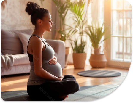 A pregnant women is sitting on the ground.