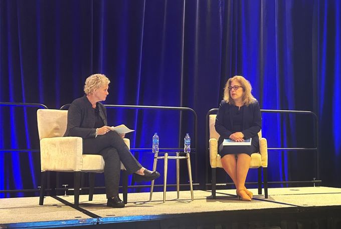 Principal Deputy Administrator Diana Espinosa is seated onstage with a presenter at the National Residency Matching Program Transition to Residency conference.