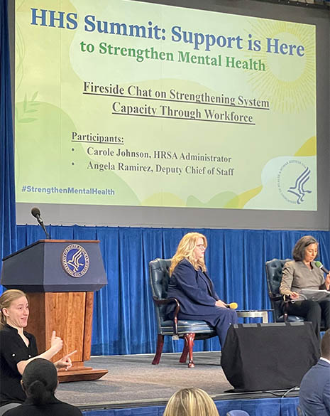 HHS Secretary Xavier Becerra speaks at a podium on stage at the HHS Mental Health Summit. on stage at the HHS Mental Health Summit. 