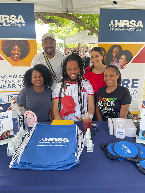 Ryan White HIV/AIDS Program staff in front of the interactive exhibit booth at the Baltimore AFRAM Festival.