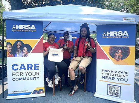 HRSA staff in the HRSA exhibit tent at the AFRAM festival.