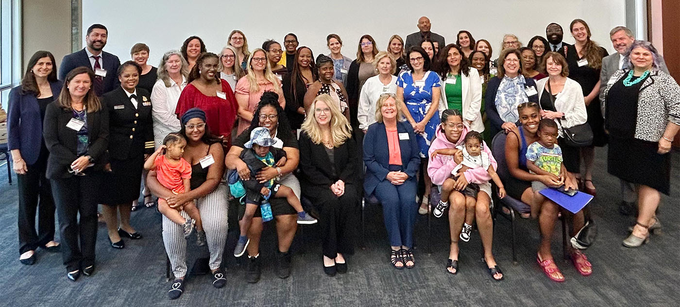 Group photo of HRSA Administrator Carole Johnson with over 40 other attendees gathered in a conference room for the Michigan convening.