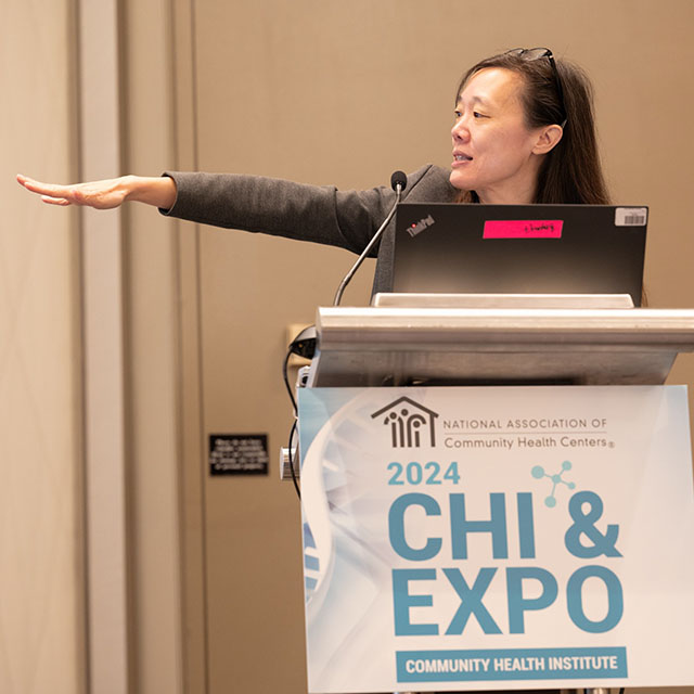 Dr. Candice Chen speaking at a podium during the 2024 Community Health Institute & Expo. 