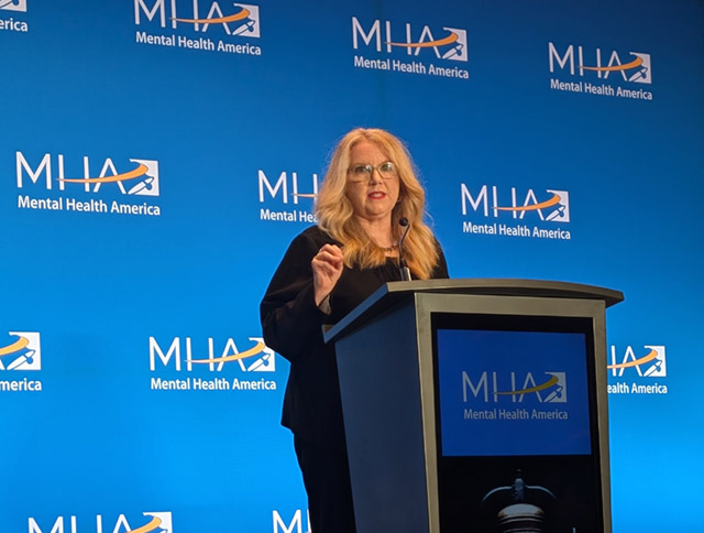 Carole Johnson with three others stand for a group portrait at the Mental Health America Conference.