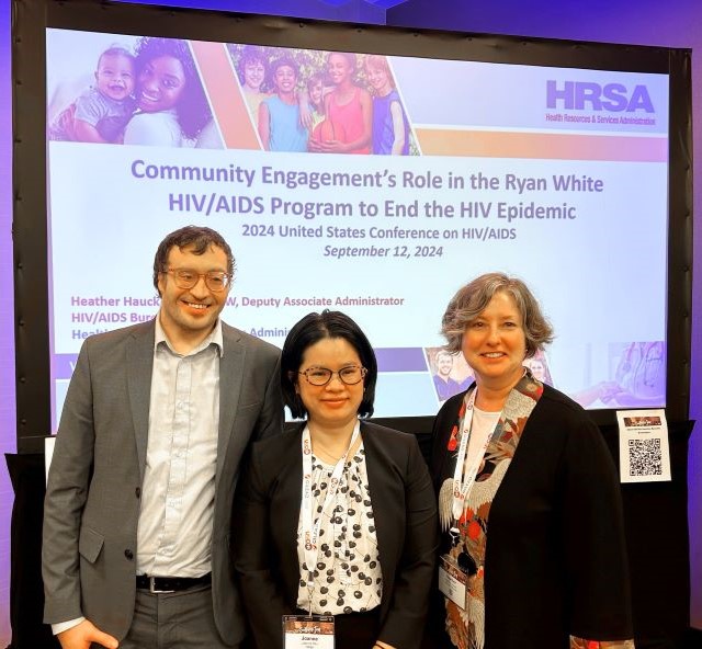 HIV/AIDS Bureau Deputy Associate Administrator Heather Hauck and two others stand for a group photo.