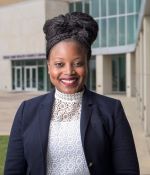 Dr. Alva Ferdinand smiles at the camera.