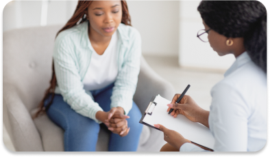 Counselor talking to girl and taking notes