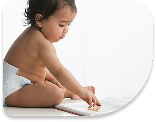 baby sitting by a tablet