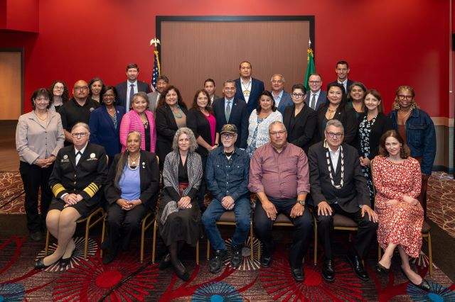 A large group photo of attendees at the Secretary’s Tribal Advisory Committee meeting.