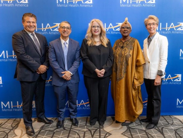 HRSA Administrator Carole Johnson with four others stand for a group portrait at the Mental Health America Conference.